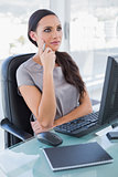 Pensive businesswoman in front of her computer