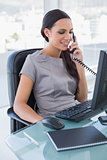 Smiling sexy businesswoman answering phone