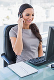 Cheerful gorgeous businesswoman on the phone