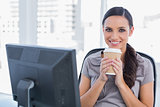 Happy attractive businesswoman having coffee