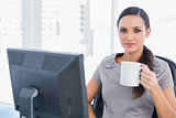 Attractive businesswoman holding mug