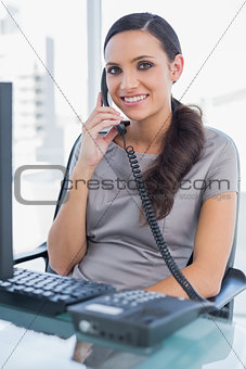 Smiling secretary answering land line