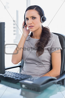 Frowning attractive secretary wearing headset