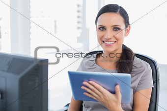 Cheerful attractive secretary using tablet pc