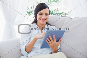 Happy brunette with tablet pc
