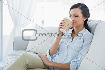 Happy seductive brunette drinking coffee