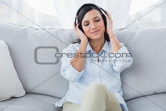 Thoughtful brunette listening to music
