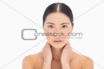 Natural model posing touching her neck