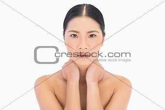 Relaxed natural model posing touching her neck