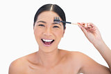 Laughing natural model using eyebrow brush