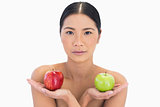 Natural brunette holding apples in both hands