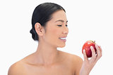 Smiling black haired model having red apple