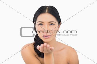 Sensual dark haired model sending a kiss to camera