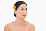Pensive dark haired model with flower in hair