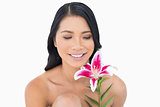 Cheerful natural black haired model posing with lily
