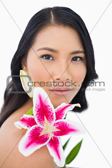 Sensual natural model posing with lily