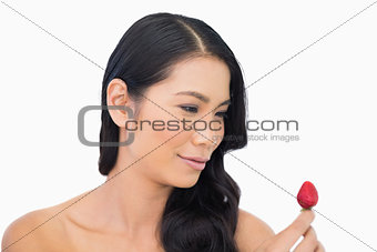 Happy gorgeous brown haired model with strawberry