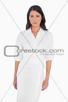 Elegant dark haired model with white dress