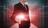 Businessman touching futuristic red light touchscreen
