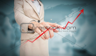 Businesswoman touching red growth arrow