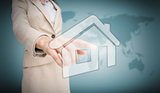 Businesswoman touching house graphic