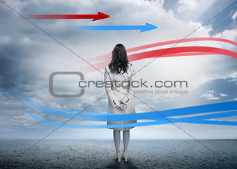 Businesswoman looking at red and blue arrows