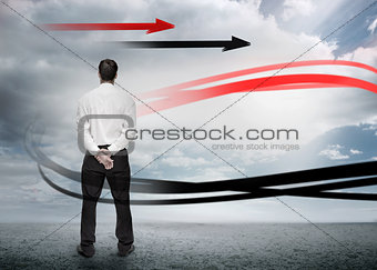Businessman looking at red and black arrows