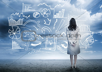 Businesswoman standing looking at data flowchart