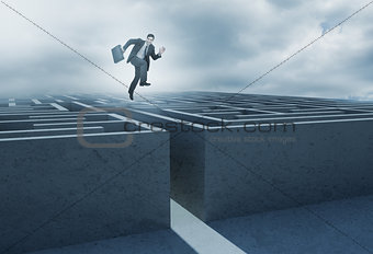 Businessman leaping above a maze
