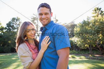 Smiling couple standing in a park