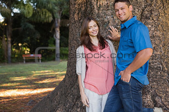 Couple leaning on a tree