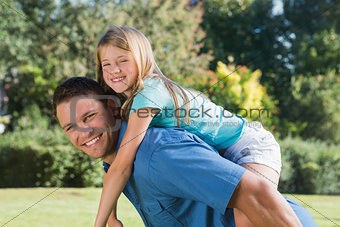 Daughter getting piggy back from dad