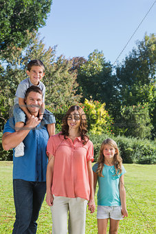 Young family posing in a park