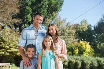 Cheerful family standing in the countryside