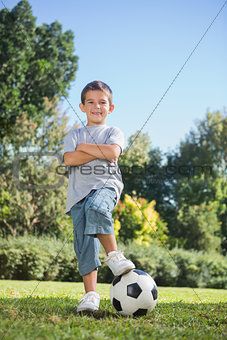 Young boy posing with football