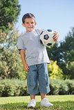 Young boy holding football