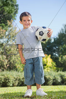Young boy holding football