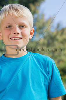 Little blonde boy smiling at camera