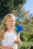 Small child blowing the pinwheel