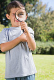 Small child looking through a magnifying glass