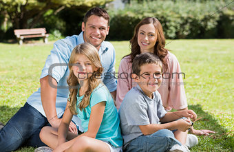 Family sitting together smiling at camera