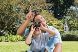 Dad and son looking at the sky with binoculars