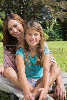 Happy mother and daughter on the grass