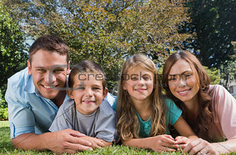 Happy family lying on the grass