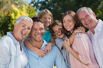 Smiling family and grandparents in the countryside embracing