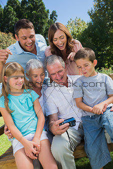 Multi generation family looking at photos