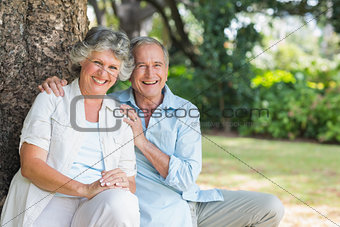 Smiling mature couple sitting together