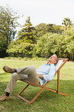 Happy man resting in sun lounger