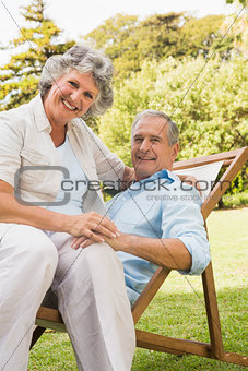 Smiling mature couple resting on sun lounger