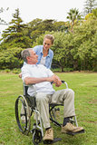 Happy man in wheelchair and daughter talking